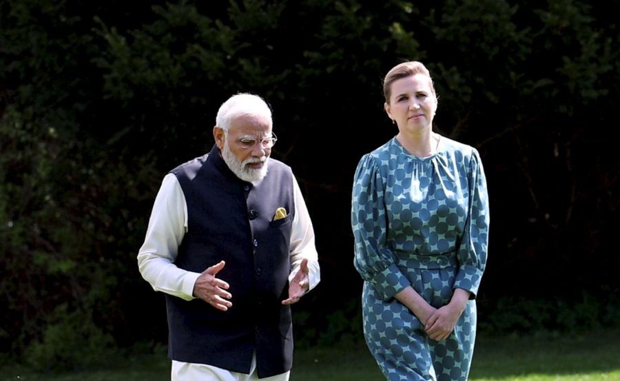 **EDS: HANDOUT PHOTO MADE AVAILABLE FROM PIB ON TUESDAY, MAY 3, 2022.** Copenhagen: Prime Minister Narendra Modi interacts with Prime Minister of Denmark Mette Frederiksen, at her residence in Copenhagen, Denmark. (PTI Photo)
